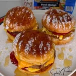 Delicious Hamburger Bun French Toast on a plate with syrup and berries