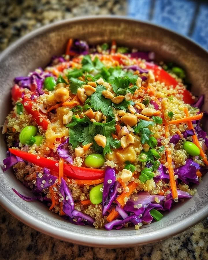 High Protein Thai Quinoa Salad with colorful vegetables and herbs served in a bowl.