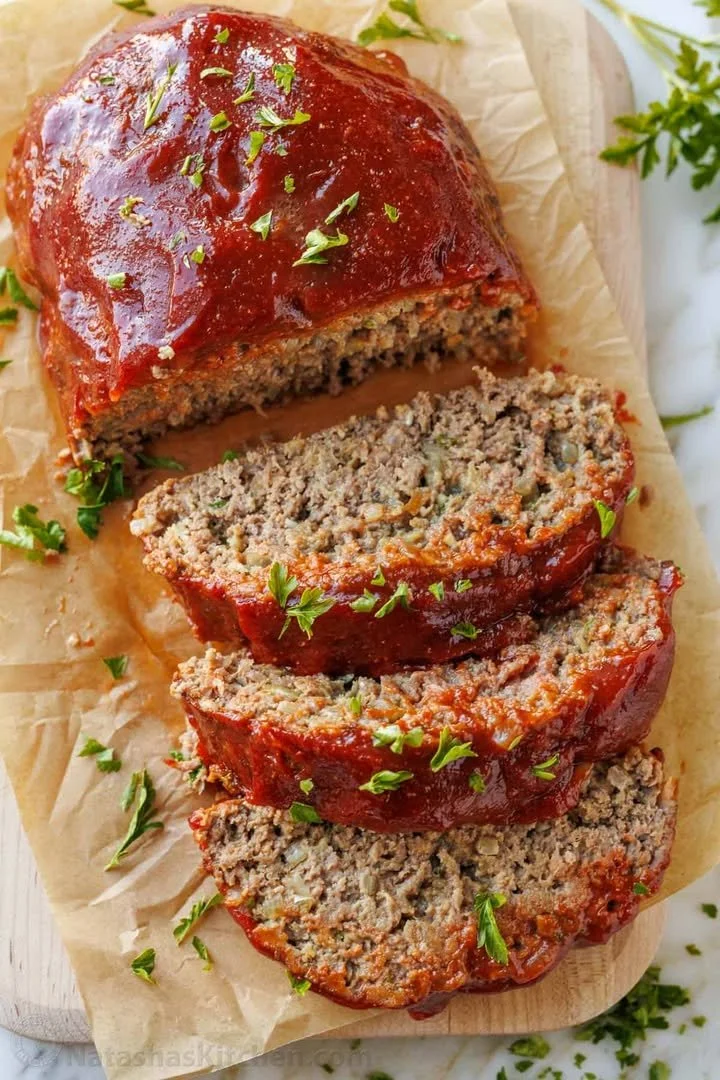 Delicious homemade meatloaf served with mashed potatoes and green beans.