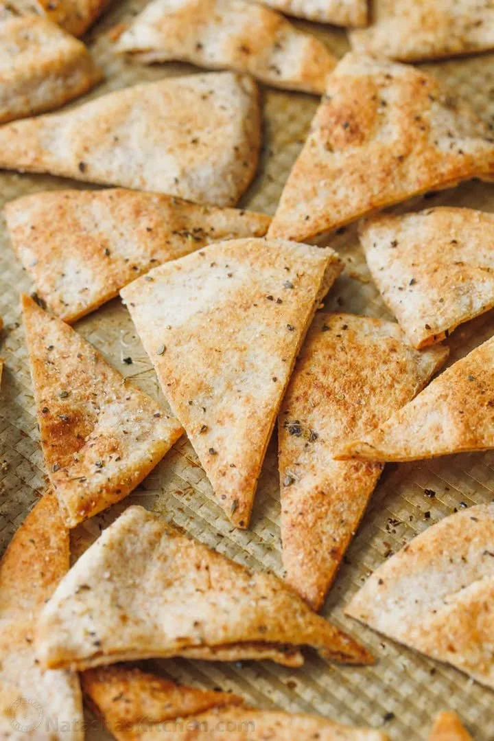 Freshly baked homemade pita chips in a bowl, ready for snacking.
