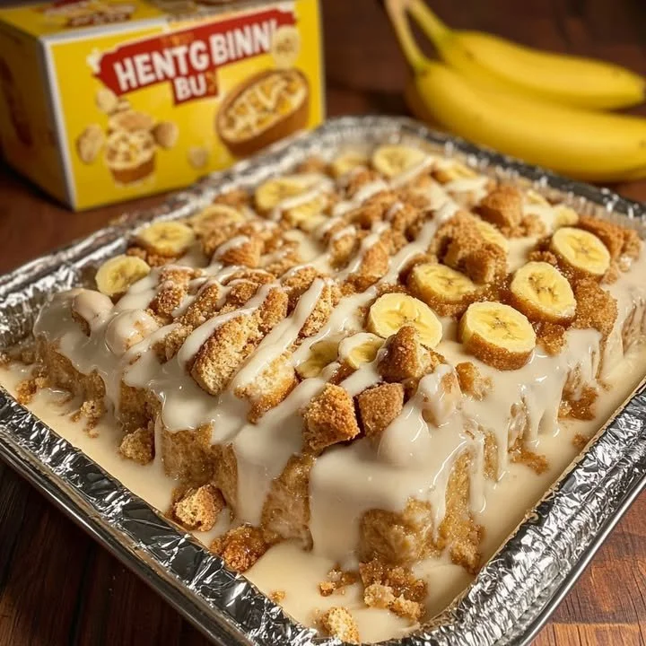 Delicious Honey Bun Banana Pudding Dessert topped with whipped cream and bananas
