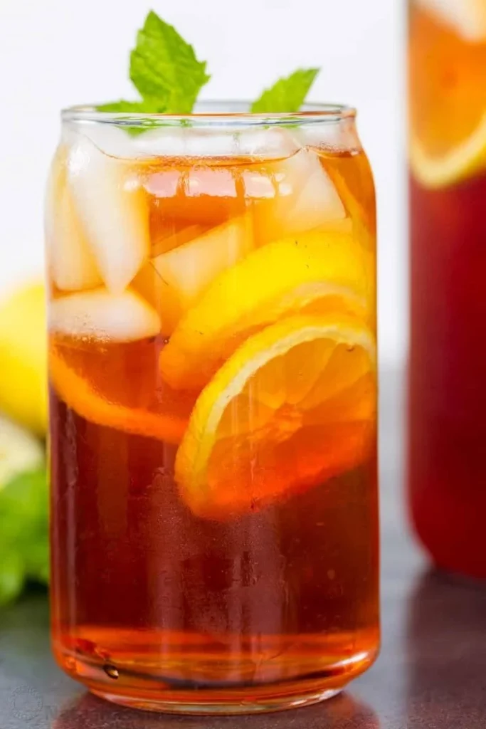 A glass of refreshing iced tea with lemon and mint