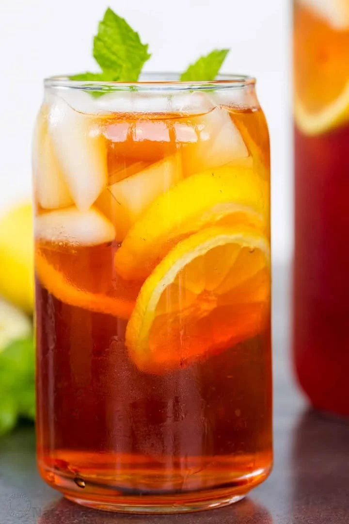 A glass of refreshing iced tea with lemon and mint