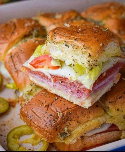 Delicious Italian sliders topped with fresh ingredients and served on a platter.