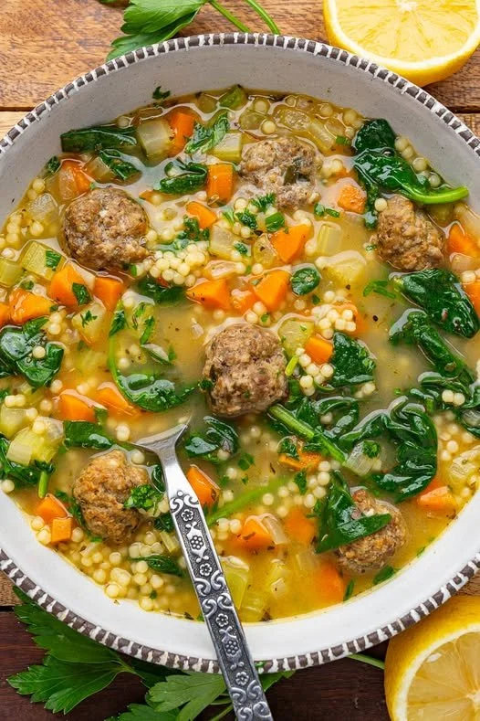 Bowl of Italian Wedding Soup with meatballs and greens