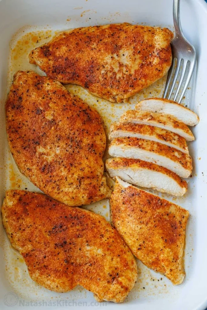 Juicy baked chicken breast garnished and ready to serve
