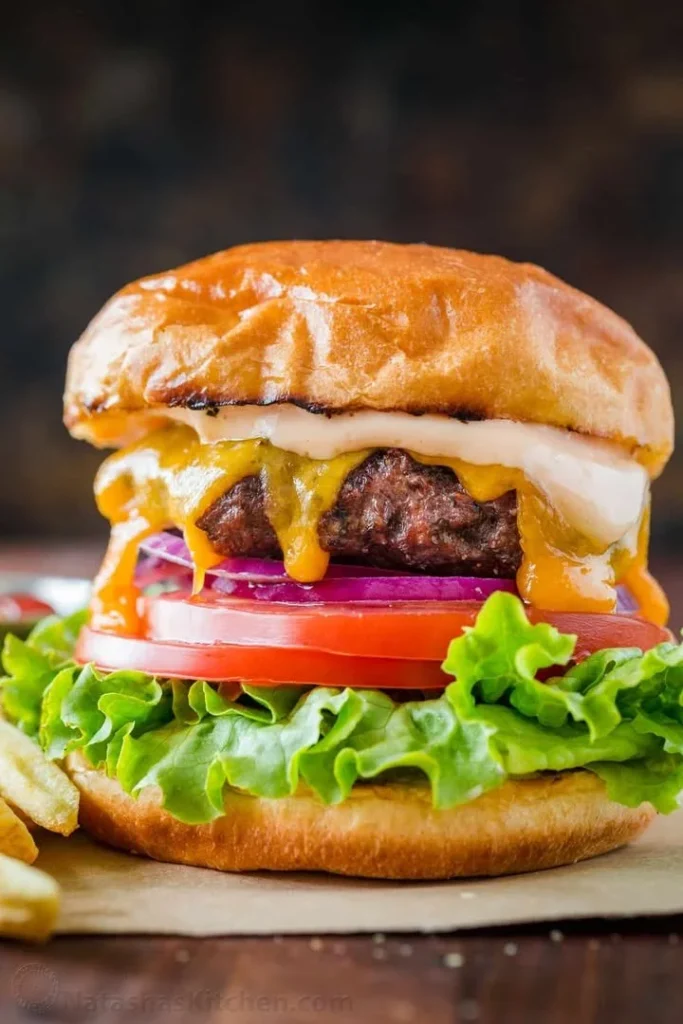 Delicious juicy burger with secret sauce on a wooden table