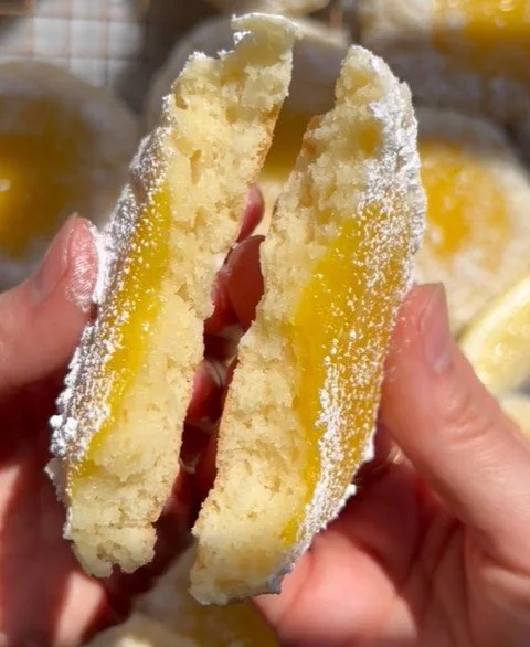 Lemon bar butter cookies on a plate with lemon zest garnish