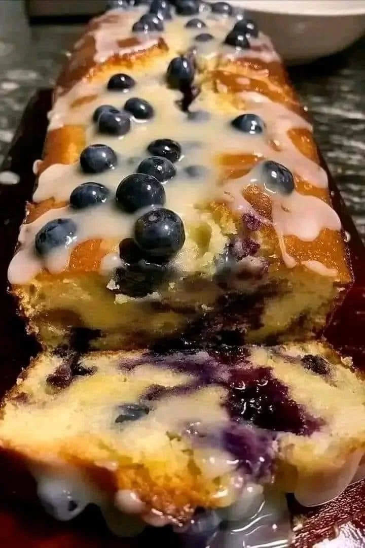 Sliced Lemon Blueberry Loaf with fresh blueberries and lemon zest