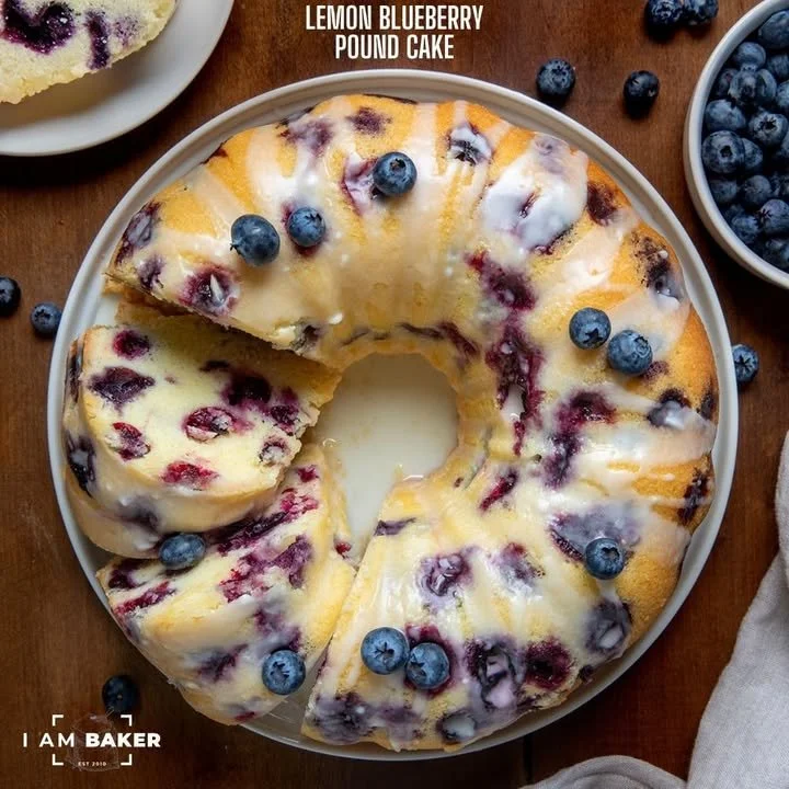 Delicious slice of Lemon Blueberry Pound Cake with blueberries and lemon zest.
