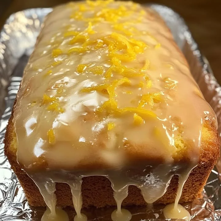 Sliced lemon loaf cake drizzled with fresh lemon glaze
