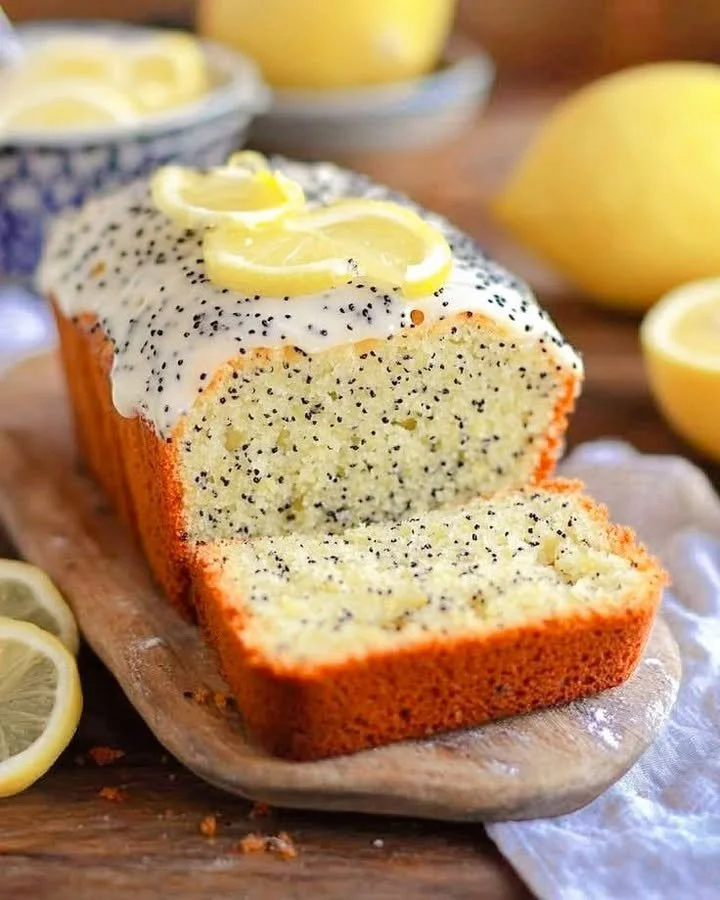 Lemon poppy seed loaf with glaze on a wooden table