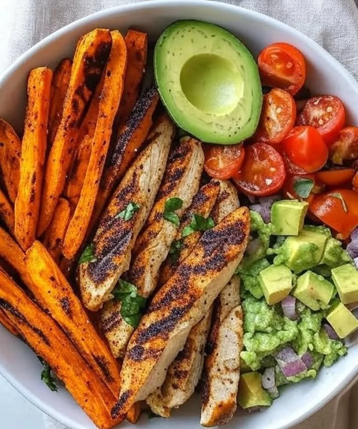 A delicious Loaded Grilled Chicken & Sweet Potato Power Bowl served in a bowl.