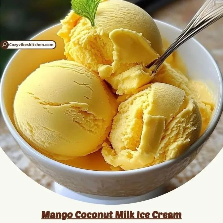 Creamy Mango Coconut Milk Ice Cream in a bowl with mango slices on top.