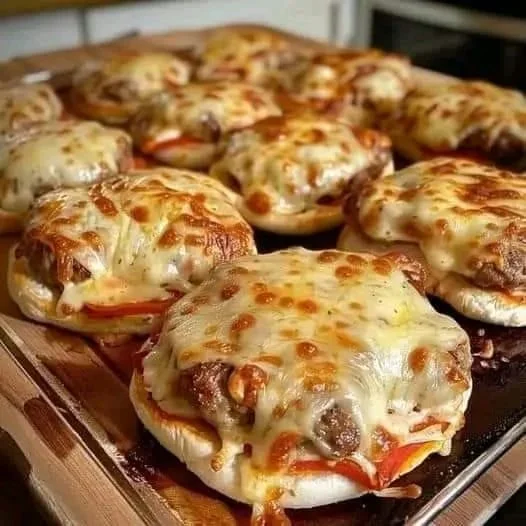 Mini pizza burgers served on a platter, ideal for appetizers and snacks.