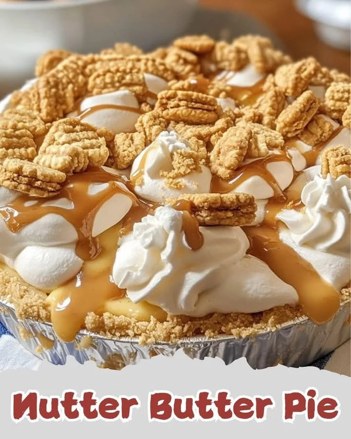 Delicious Nutter Butter Pie topped with whipped cream and crushed cookies