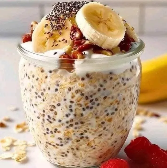 Bowl of overnight oats topped with chia seeds and fresh fruits