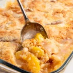 Delicious Peach Dump Cake topped with juicy peaches and crumbly goodness.