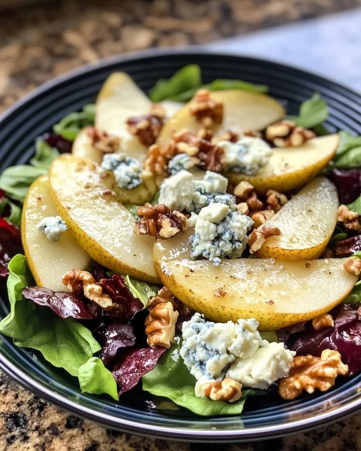 Fresh pear blue cheese walnut salad with a drizzle of balsamic vinaigrette.