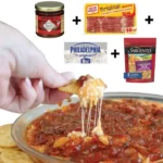 Delicious pepper jelly cheese dip served with crackers and garnished with herbs