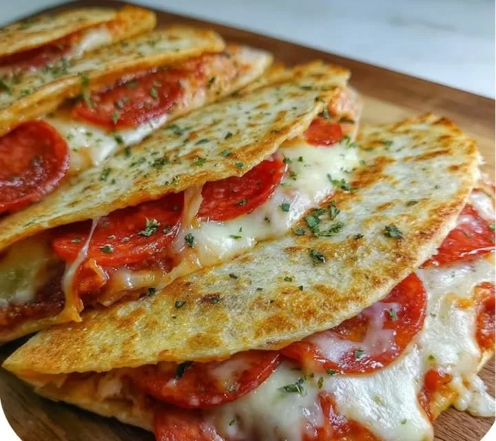 Melted cheese and pepperoni pizza quesadillas served on a plate
