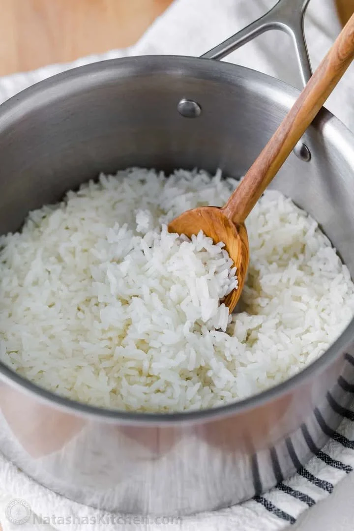 Perfectly cooked fluffy white rice in a bowl garnished with herbs