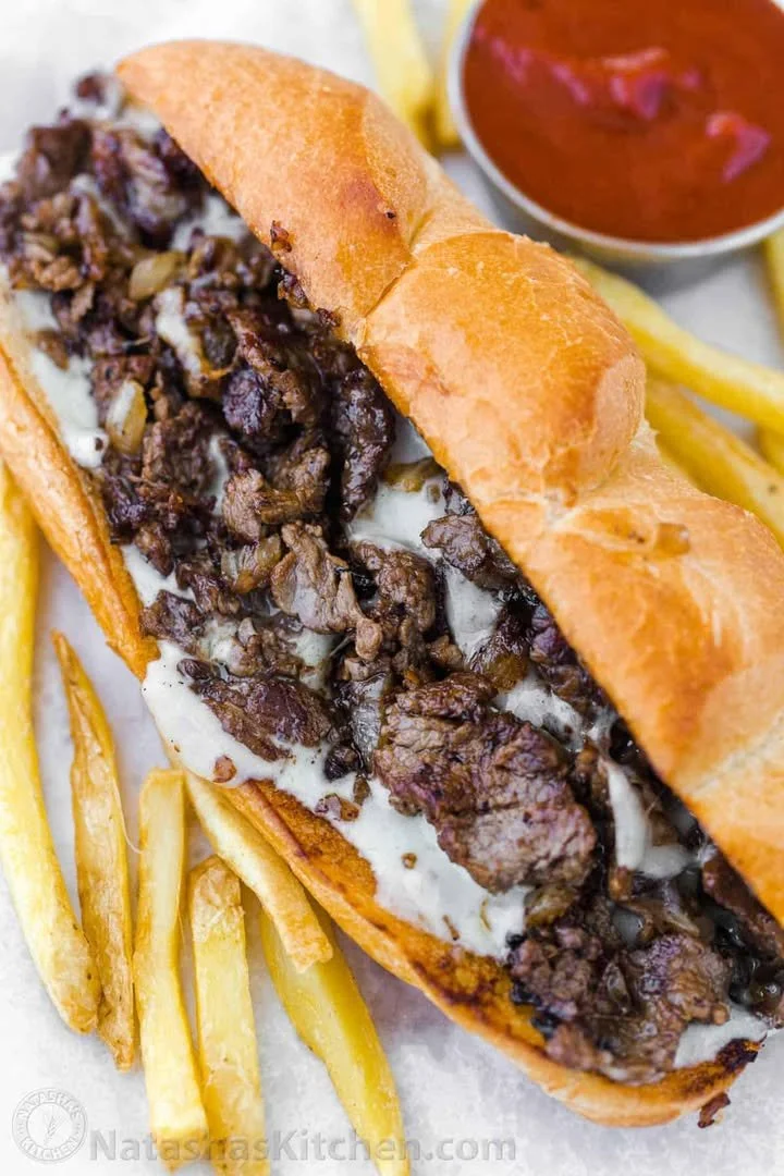 Authentic Philadelphia cheesesteak served in a soft roll with toppings.