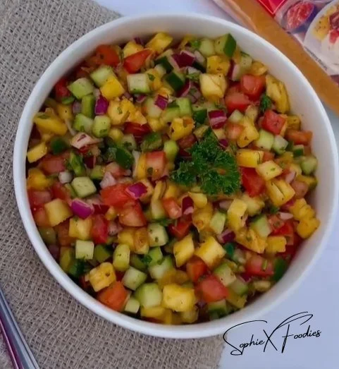 Fresh pineapple salsa served in a bowl with cilantro and lime