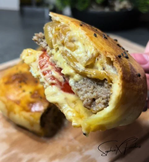 Delicious Pizza Burger with toppings and melted cheese on a bun.