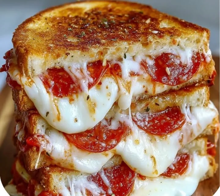 Mouthwatering Pizza Grilled Cheese Sandwiches with melted cheese and pizza toppings