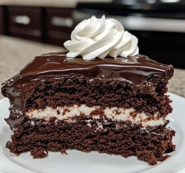 Slice of delicious Polish WZ Cake with cream and chocolate garnish