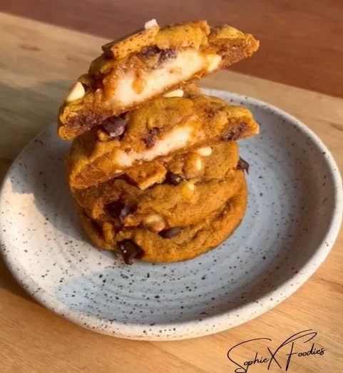Pumpkin cheesecake cookies topped with creamy frosting, ideal for fall desserts