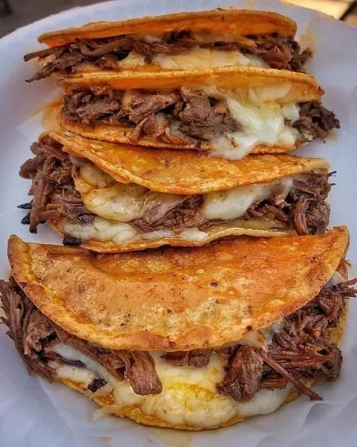 Delicious quesabirria tacos with tender meat and melty cheese
