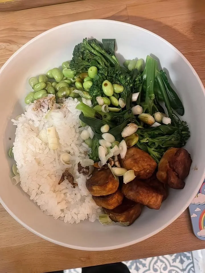 Healthy rice bowl topped with steamed greens and fried tofu