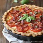 Delicious roasted garlic tomato pie topped with crispy bacon