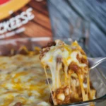 Delicious Walking Taco Bake casserole topped with Fritos and cheese, easy recipe.