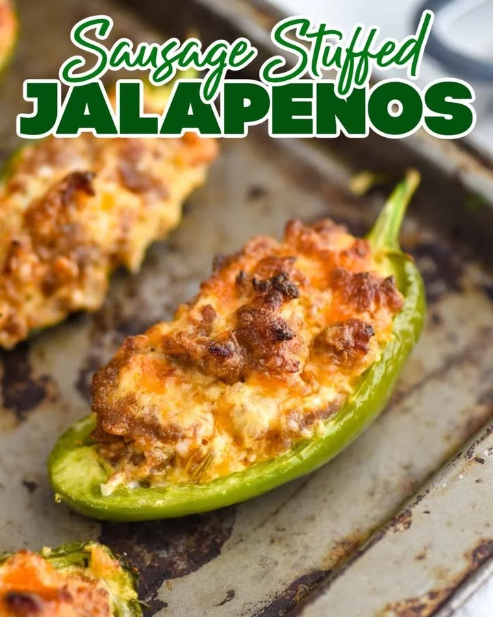 Sausage stuffed jalapeños on a platter, ready to serve as appetizers.