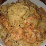 Delicious Shrimp Fettuccine Alfredo served in a creamy white sauce