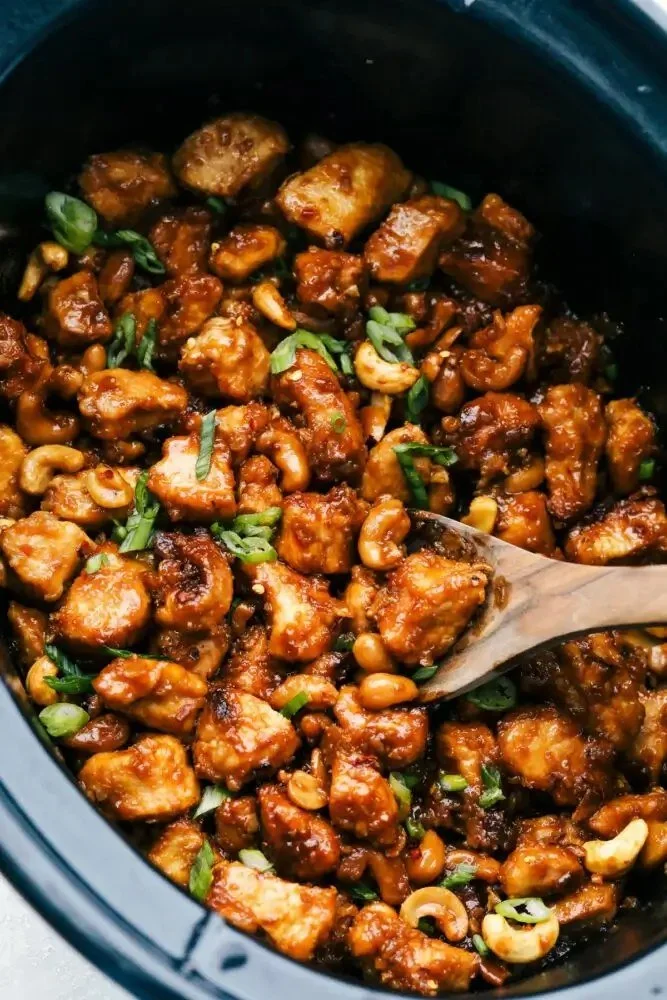 Delicious Slow Cooker Cashew Chicken served with rice and vegetables