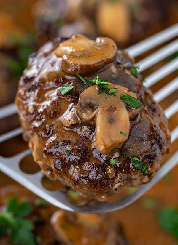 Slow Cooker Salisbury Steak served with mashed potatoes and gravy.