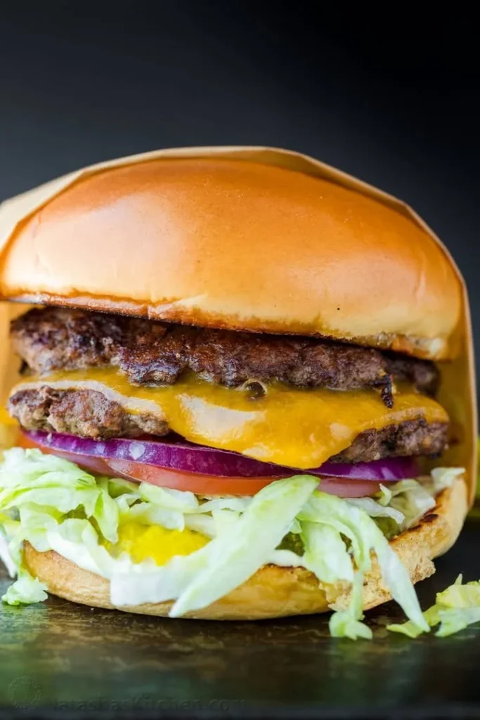 Delicious Smash Burger with melted cheese and toppings on a toasted bun