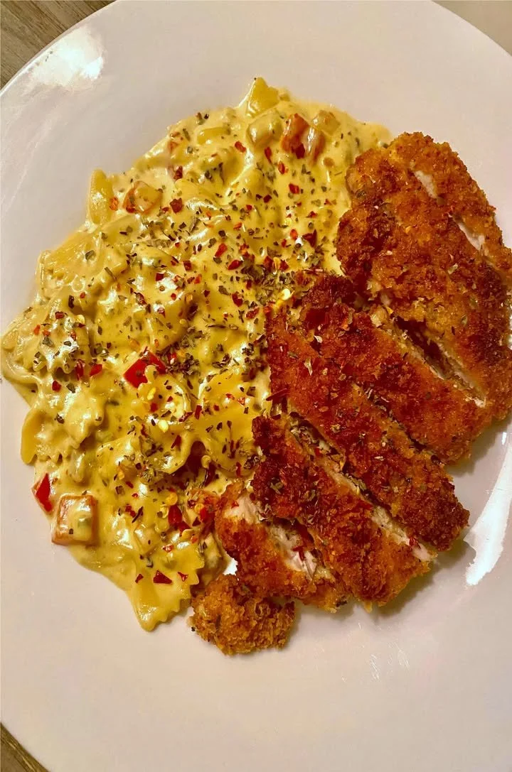 Spicy Cajun Chicken Pasta served with fresh herbs and creamy sauce
