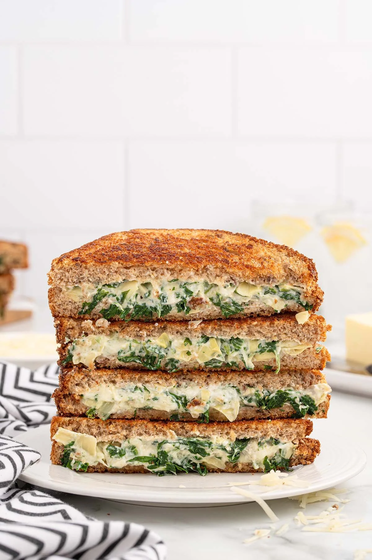 Spinach and Artichoke Grilled Cheese sandwich with melted cheese and greens.