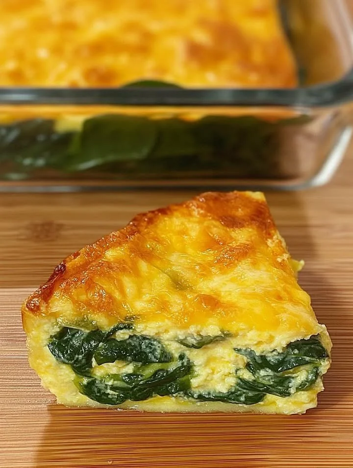 A nutritious dish of spinach and eggs cooked together in a skillet.