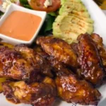 Delicious sticky wings glazed with a savory sauce on a plate