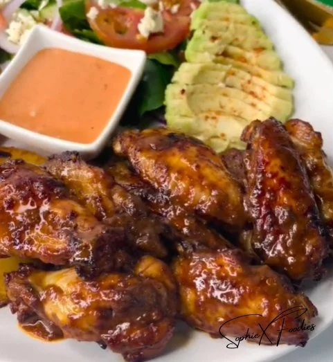Delicious sticky wings glazed with a savory sauce on a plate