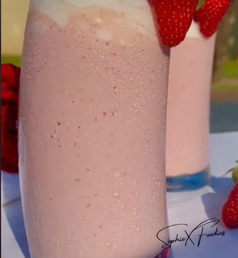 Delicious strawberry milkshake topped with whipped cream and fresh strawberries