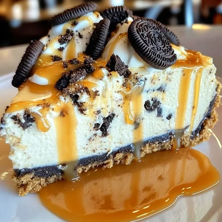 Slice of Summer Caramel Oreo Cheesecake with caramel drizzle and Oreo crust