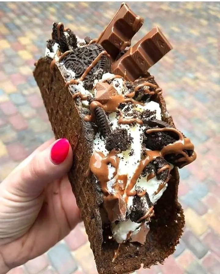 Summer chocolate ice cream taco topped with sprinkles and served in a waffle shell.