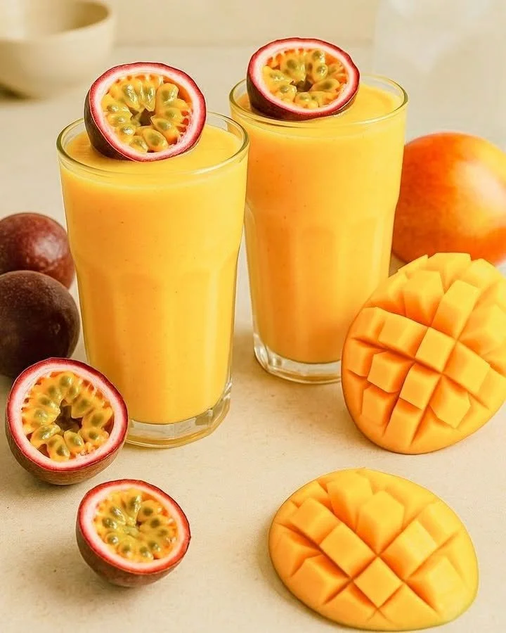 Delicious summer mango passionfruit smoothie in a glass with fresh fruit